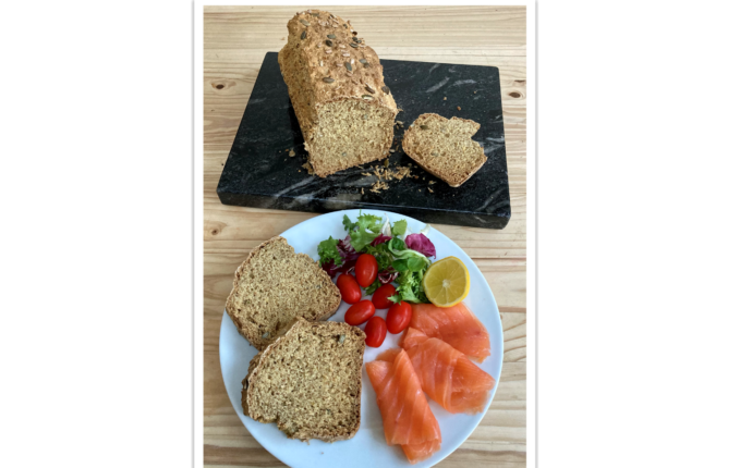 Irish Soda Bread slices served on a place with with smoked salmon and salad.