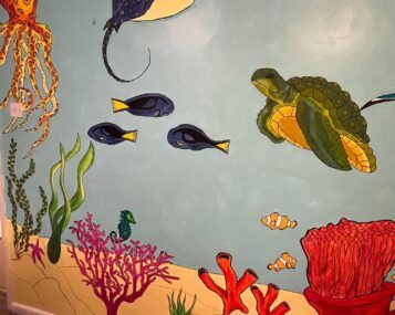 A photo of some sea-themed wall art in progress, including some fish, a turtle and an octopus.