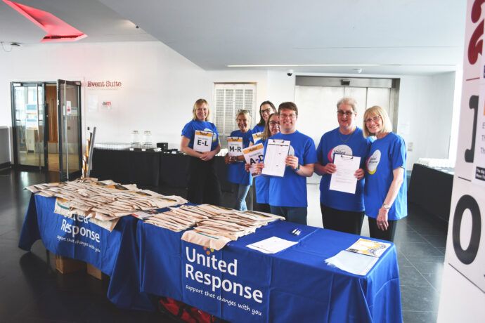 This is a picture of volunteers stood ready to welcome people to More Than a Provider. 